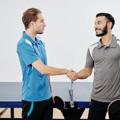 Table tennis players shaking hands